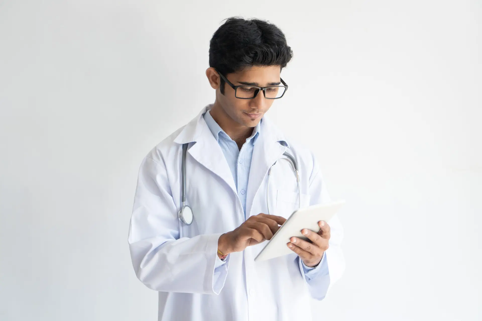 portrait confident young doctor glasses using pc tablet scaled